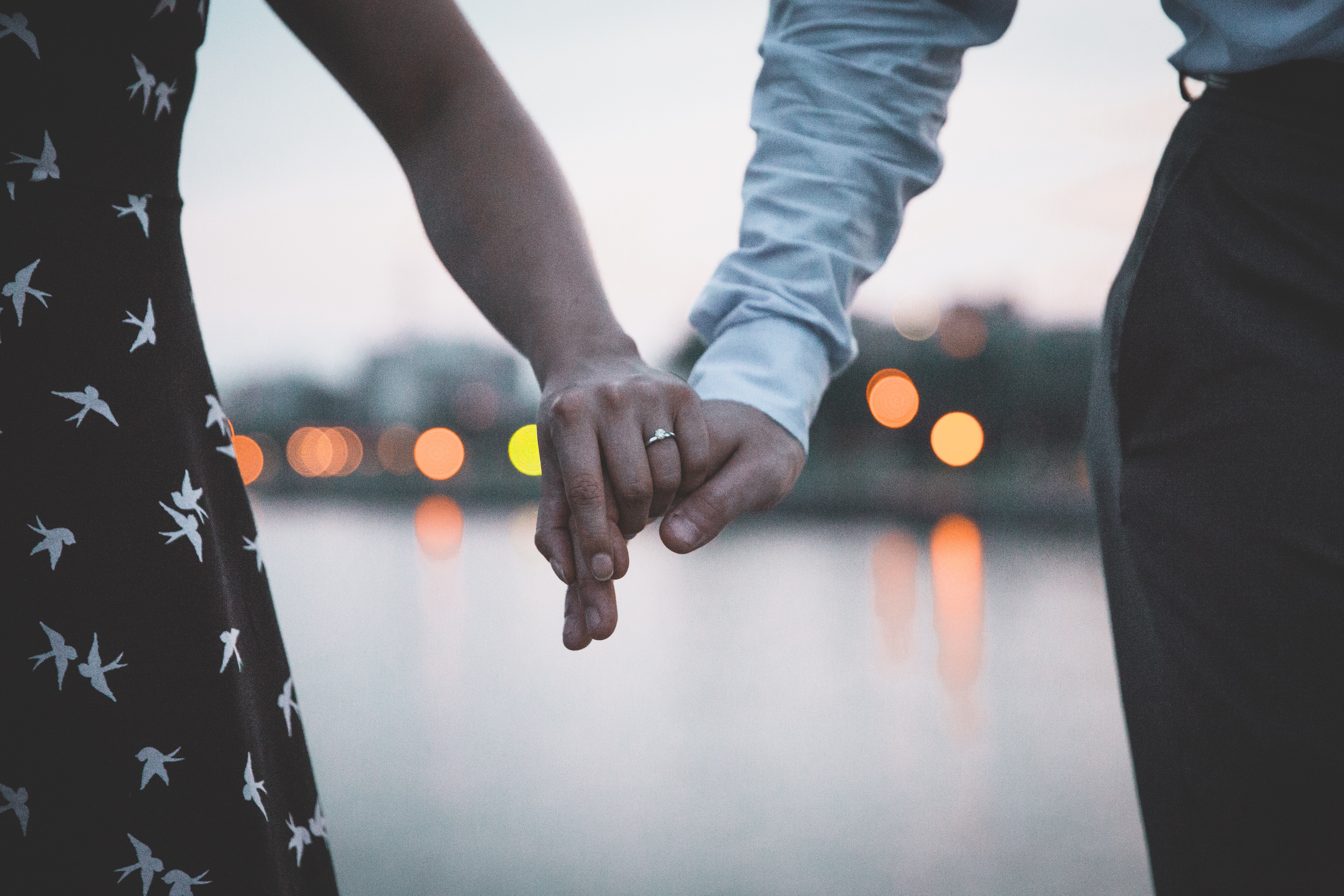 couple holding hands with accessories